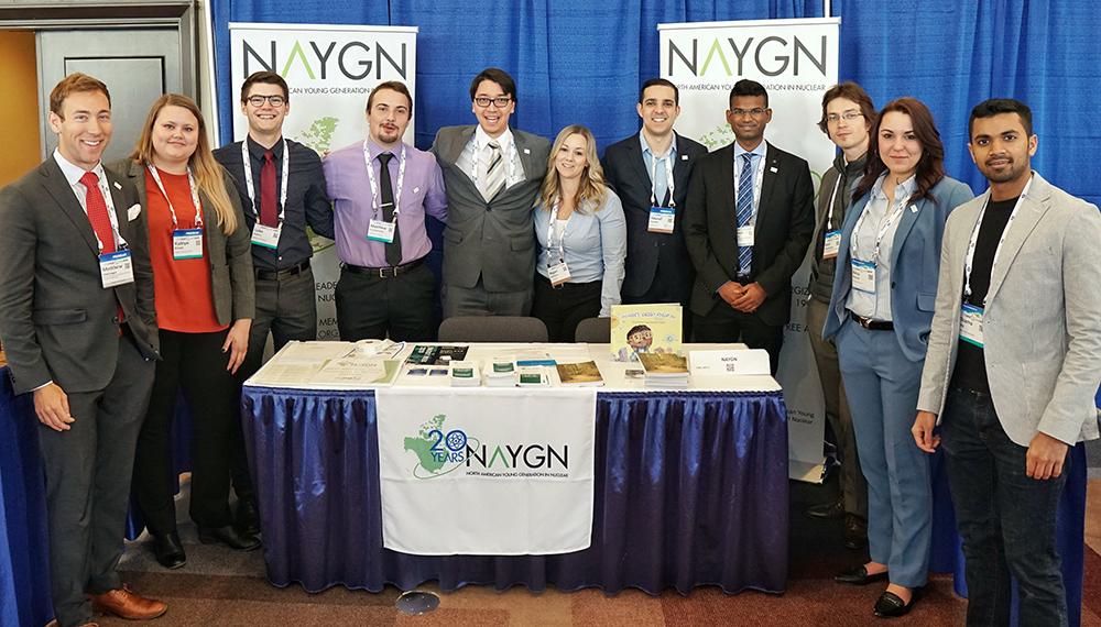 Event attendees pose for photo with NAYGN sign
